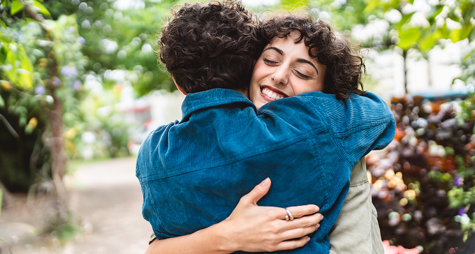 people embracing, expressing trust and positive connection

