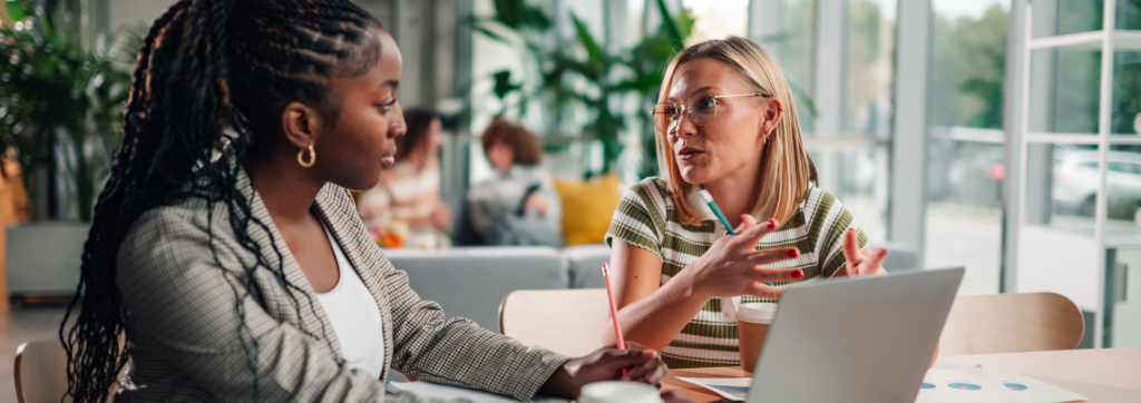 two colleagues discussing ideas during meeting