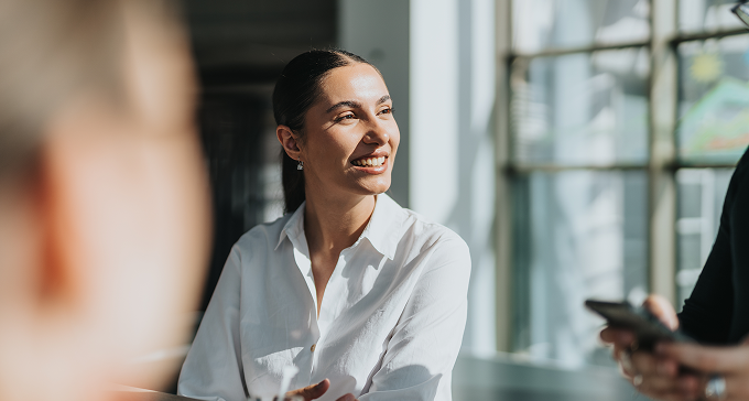 woman speaking during meeting in office
